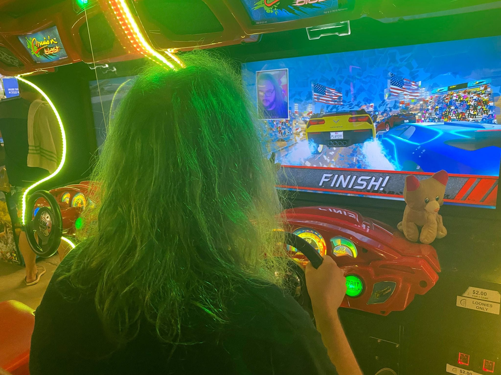 A man with green hair plays a modern driving game, Photo 13